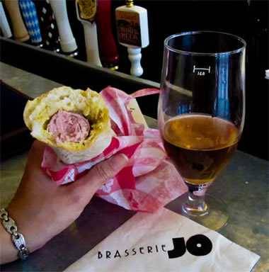 eating chien blanc sausage at Brasserie Jo eating chien blanc sausage at Brasserie Jo