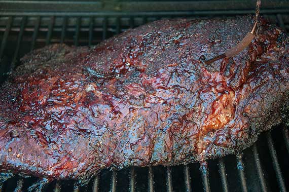 Anatomy illustration of a full packer brisket showing the point muscle, flat muscle, fat cap, and fat layers.