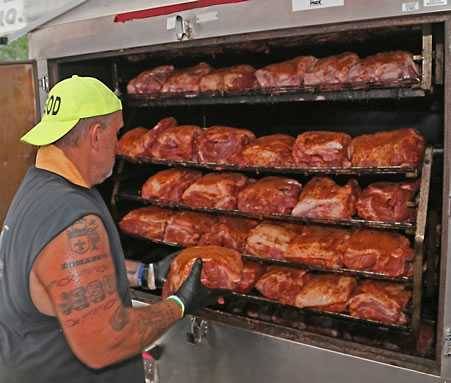 Loading pork butts in a smoker for Operation BBQ Relief Loading pork butts in a smoker for Operation BBQ Relief