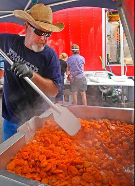 It's not all meat volunteer steaming vegetables in large pit