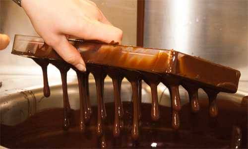 filling a mold with chocolate