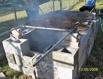 simple concrete hog pit with a chain link fence as a cooking grate simple concrete hog pit with a chain link fence as a cooking grate