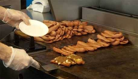 Griddle cooking dogs at Nick Tahou's in Rochester Griddle cooking dogs at Nick Tahou's in Rochester