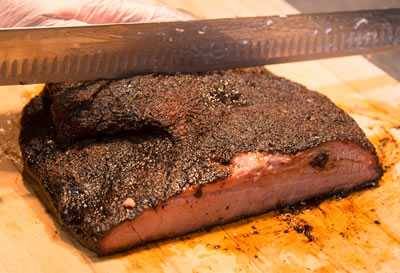 Barry Sorkin cutting a brisket in half through the point and the flat muscles.