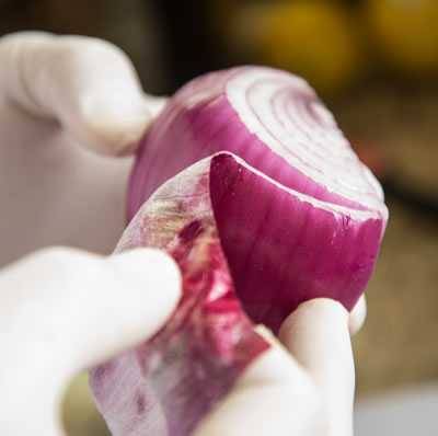 peeling the outer skin off the onion