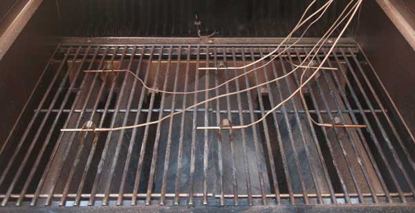 Barbecue cooking grate with wires attached